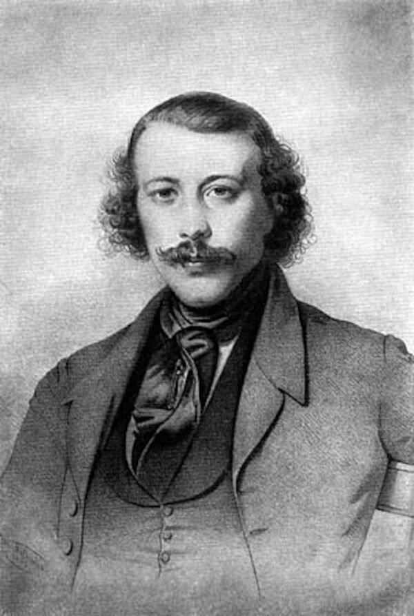 Bakunin schaut geradeaus auf die betrachtende Person, mit leicht ergrautem, struppigem Haar und Bart.